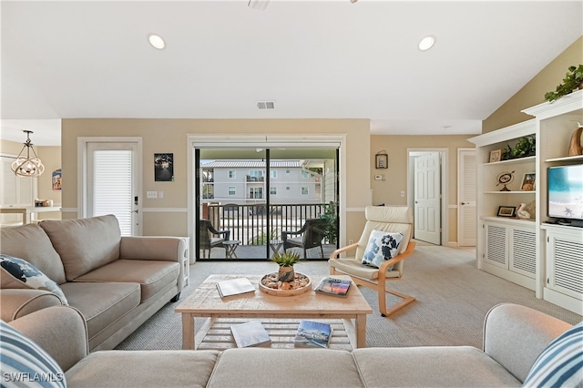 carpeted living room with lofted ceiling and a notable chandelier