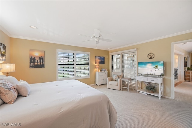 carpeted bedroom with ornamental molding and ceiling fan