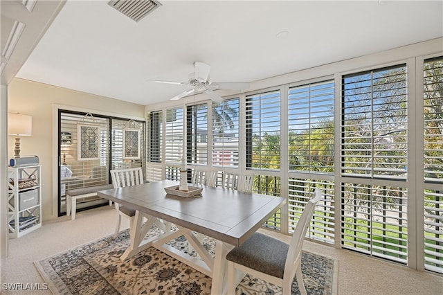 sunroom with a wealth of natural light and ceiling fan