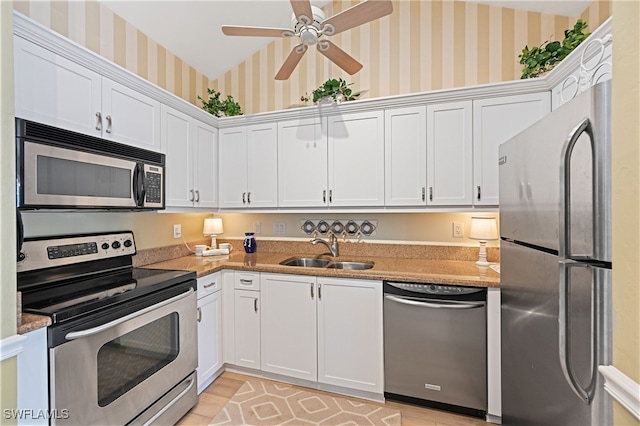 kitchen featuring light wood-type flooring, white cabinets, sink, and stainless steel appliances