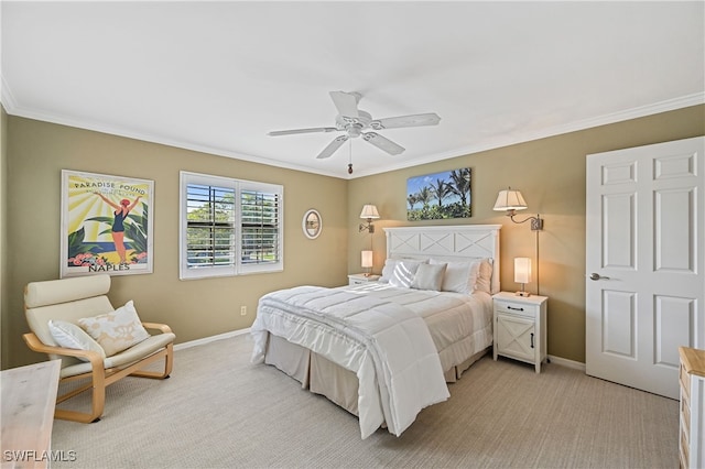 carpeted bedroom with ornamental molding and ceiling fan