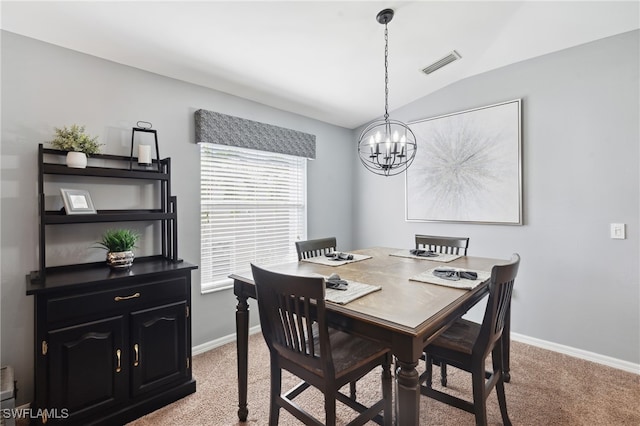 carpeted dining space with an inviting chandelier and vaulted ceiling