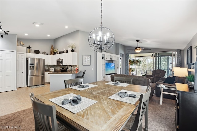 tiled dining space featuring vaulted ceiling and ceiling fan with notable chandelier