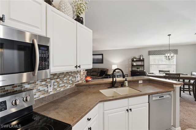 kitchen featuring white cabinetry, pendant lighting, sink, and stainless steel appliances