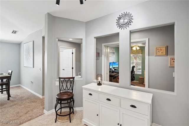 hallway with light colored carpet