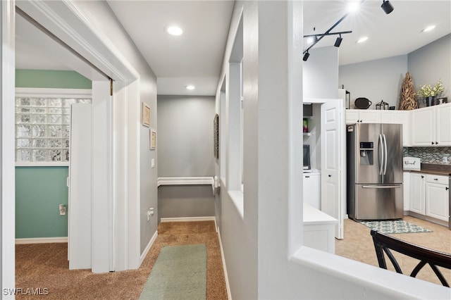 hallway with light colored carpet