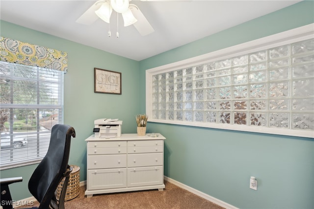 home office with light carpet and ceiling fan