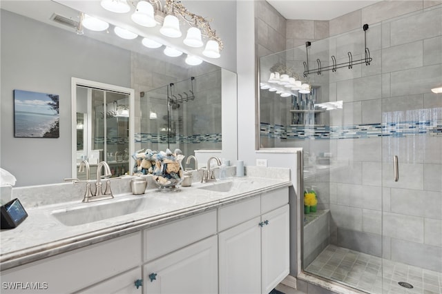 bathroom with walk in shower and vanity