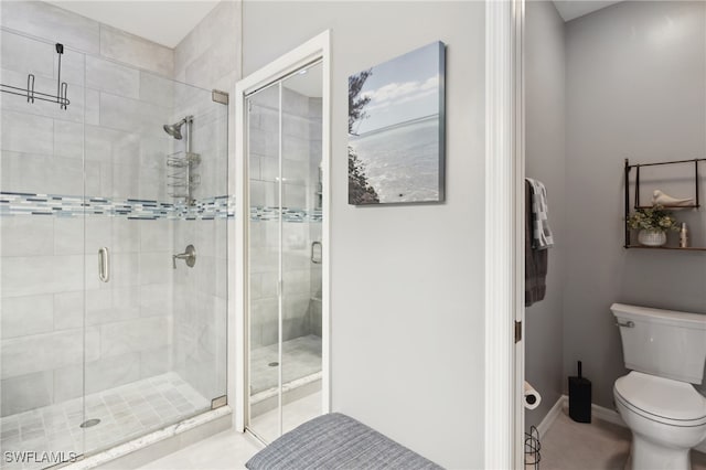 bathroom featuring an enclosed shower and toilet