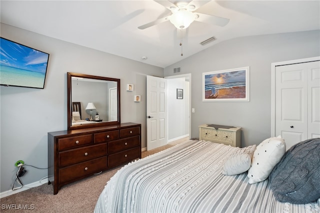 bedroom featuring ceiling fan, light carpet, a closet, and lofted ceiling