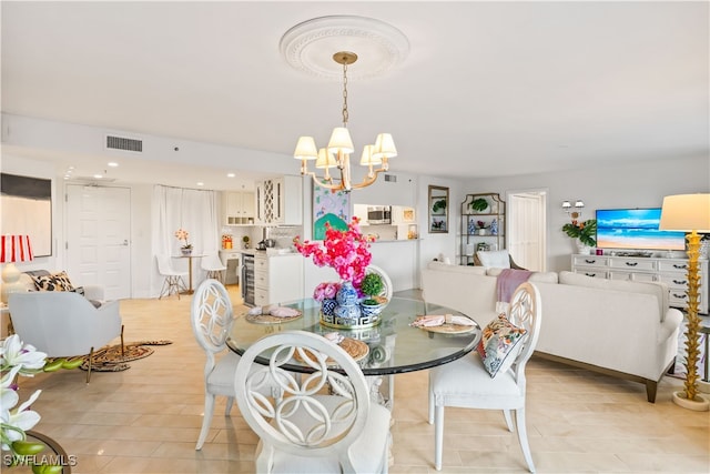 dining area with a notable chandelier and light tile patterned floors