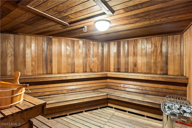 view of sauna featuring hardwood / wood-style floors, wooden walls, and wood ceiling