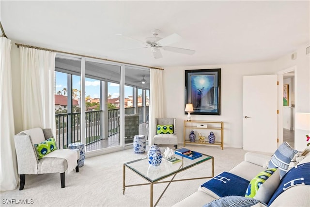 carpeted living room with ceiling fan