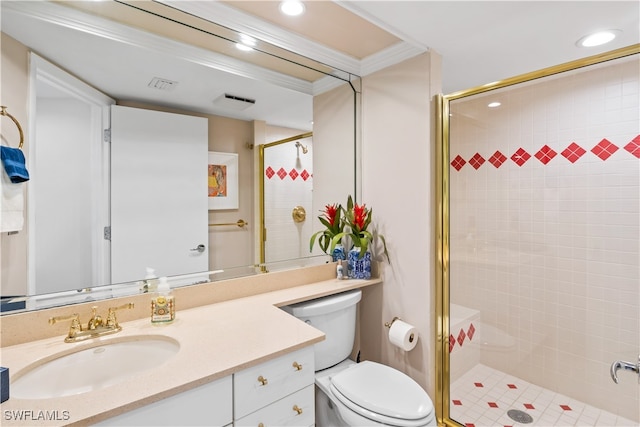 bathroom featuring toilet, vanity, a shower with door, and crown molding