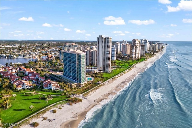 birds eye view of property featuring a view of the beach, a water view, and a view of city