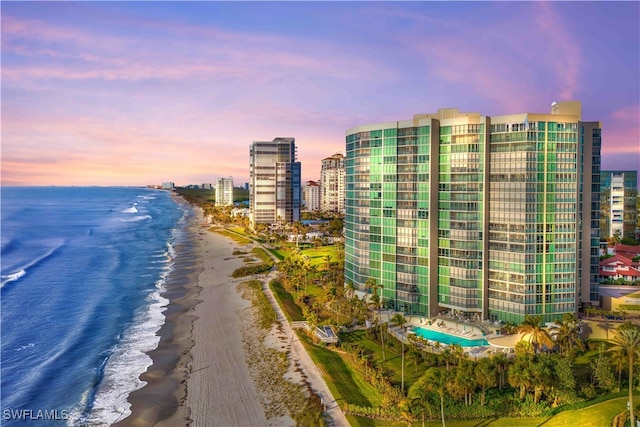 exterior space with a water view and a beach view