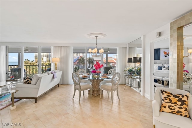 dining area featuring a chandelier, a wealth of natural light, and light hardwood / wood-style floors