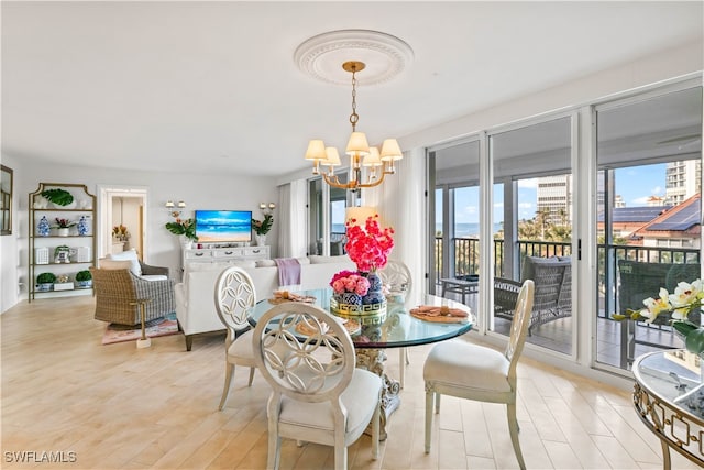 dining room featuring a notable chandelier and light hardwood / wood-style flooring