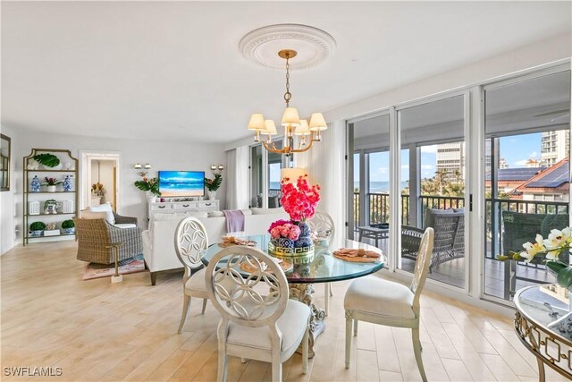dining room featuring light wood finished floors and an inviting chandelier