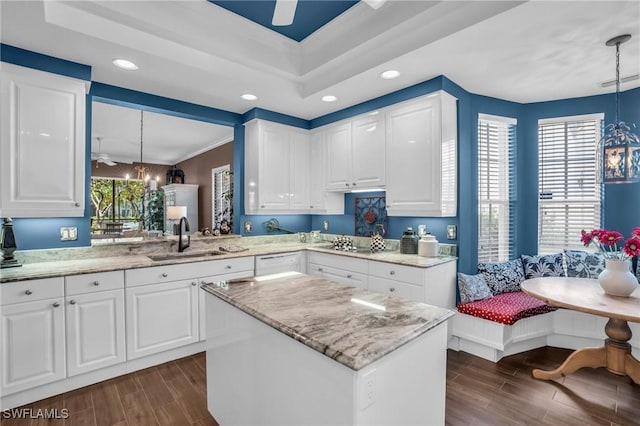 kitchen featuring breakfast area, wood finish floors, a sink, and light stone countertops