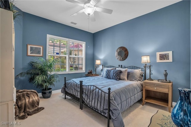 carpeted bedroom featuring visible vents, ceiling fan, and baseboards