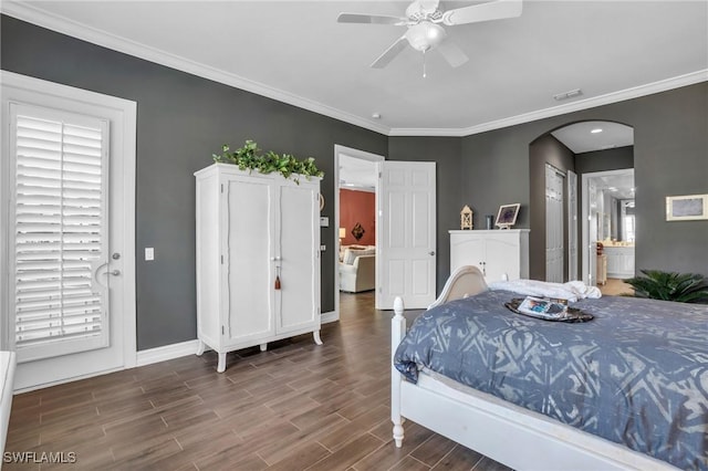 bedroom with wood tiled floor, visible vents, arched walkways, and crown molding