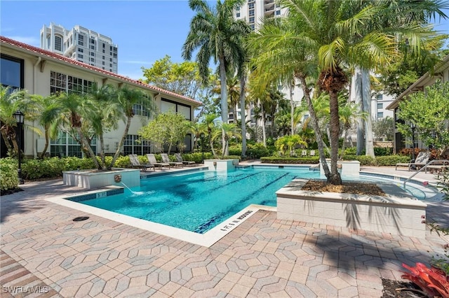 community pool with a patio area