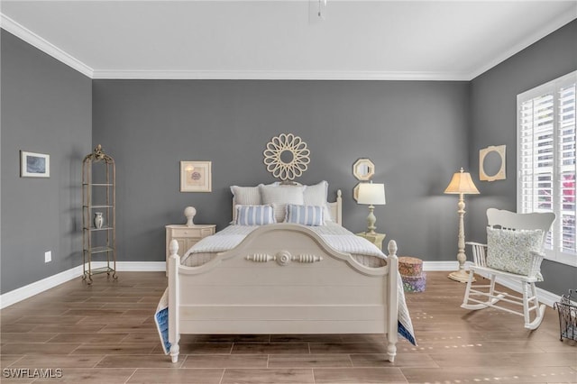 bedroom featuring wood tiled floor, crown molding, and baseboards