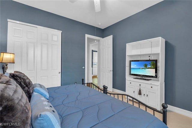 bedroom with ceiling fan, baseboards, and a closet