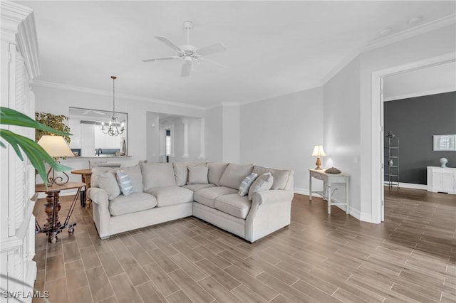 living room with wood tiled floor, crown molding, baseboards, and ceiling fan with notable chandelier