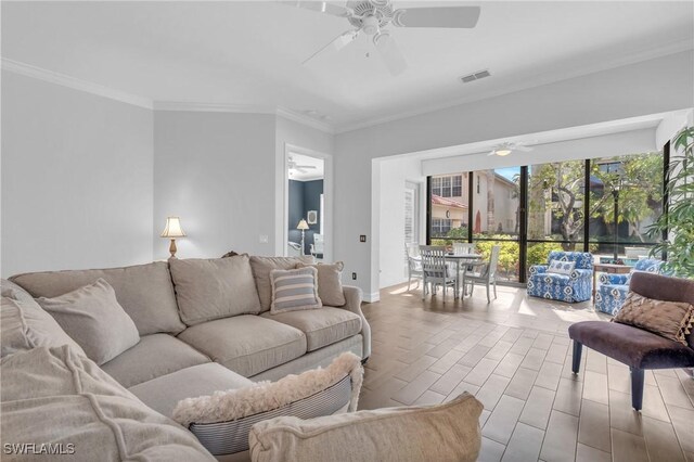 living area with crown molding, visible vents, a ceiling fan, and wood finished floors