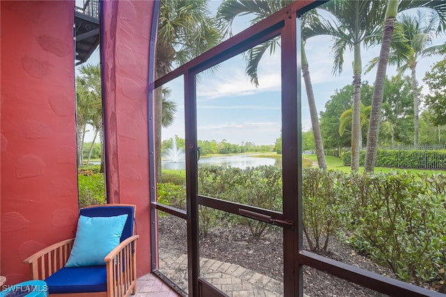 sunroom / solarium with a water view