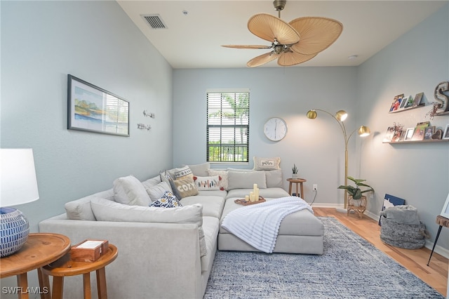 living room with ceiling fan and light wood-type flooring