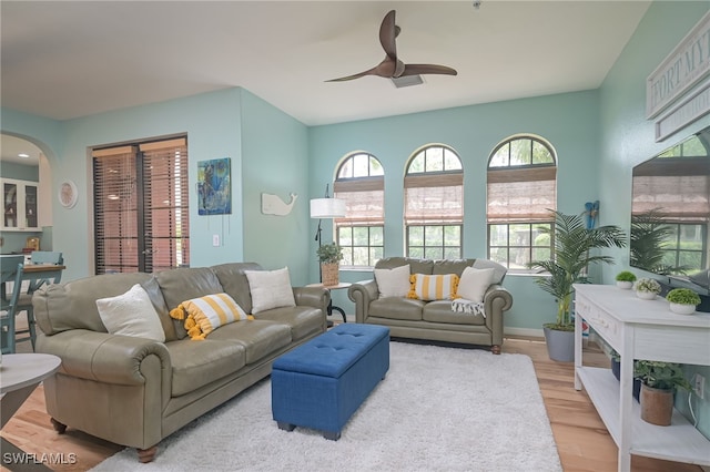 living room featuring light wood-type flooring and ceiling fan