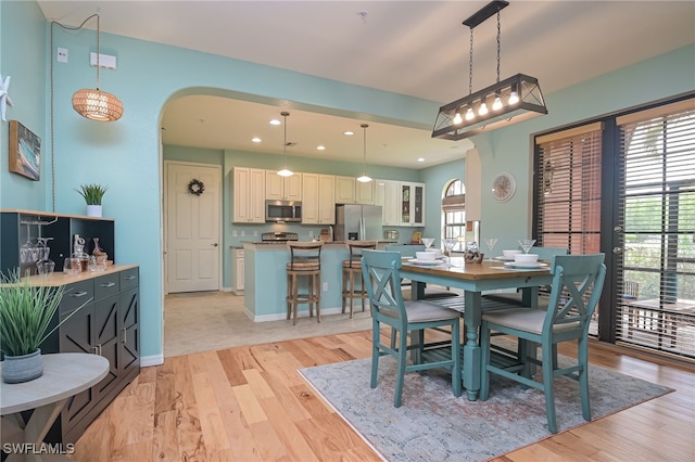 dining space featuring light wood-type flooring