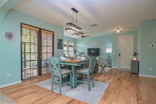 dining room featuring light wood-type flooring and a wealth of natural light