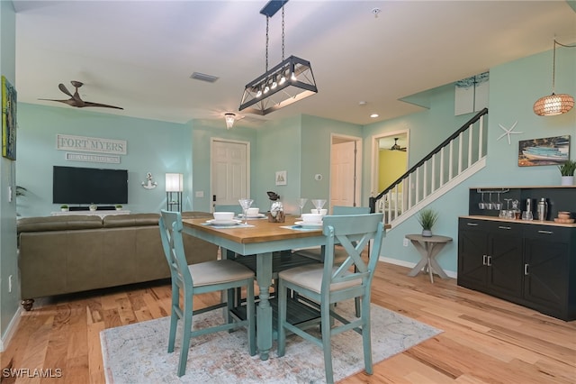 dining room with light wood-type flooring and ceiling fan