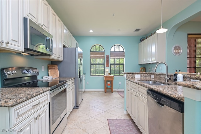 kitchen featuring stone countertops, sink, white cabinetry, and stainless steel appliances