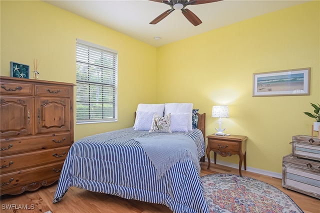 bedroom with light hardwood / wood-style floors and ceiling fan