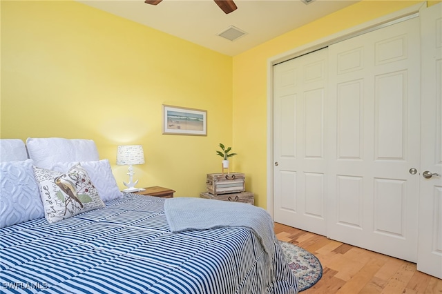 bedroom with ceiling fan, light hardwood / wood-style floors, and a closet