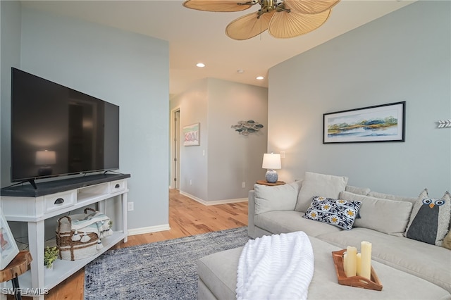 living room with ceiling fan and light hardwood / wood-style floors