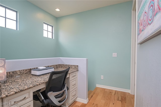 office area featuring built in desk and light hardwood / wood-style flooring