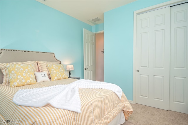 bedroom featuring light carpet and a closet