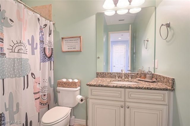 bathroom with vanity, a shower with shower curtain, and toilet