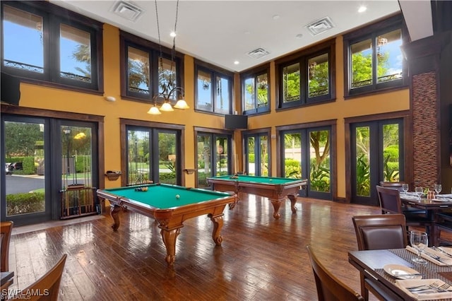 game room with a wealth of natural light, french doors, hardwood / wood-style floors, and billiards