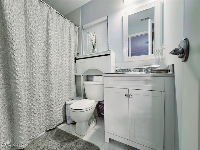 bathroom with tile patterned flooring, vanity, and toilet