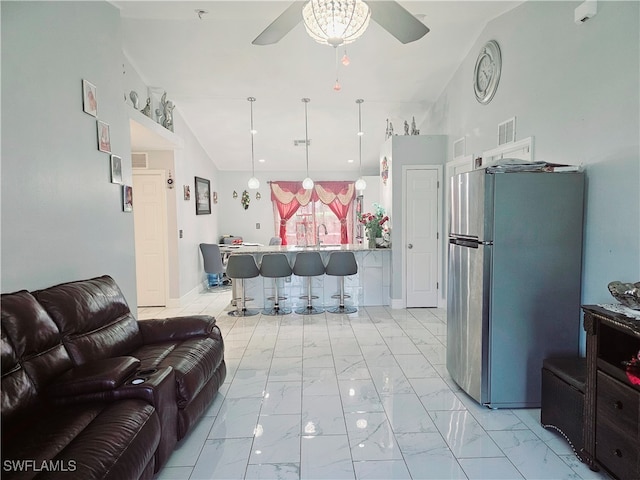 living room with ceiling fan and vaulted ceiling