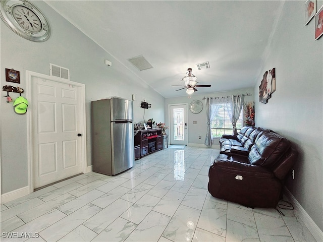 living room featuring ceiling fan and vaulted ceiling