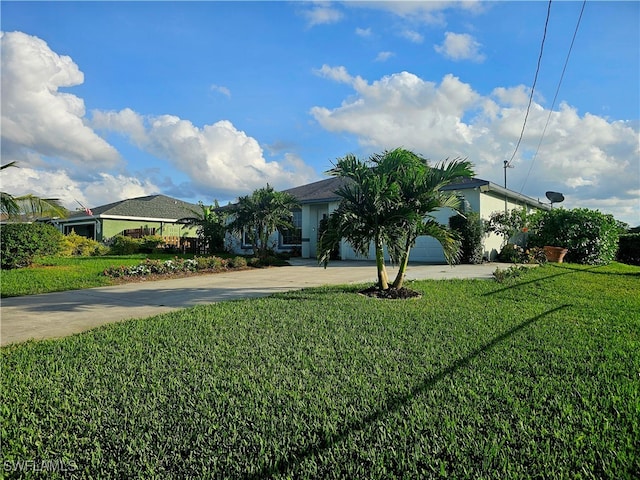 view of front facade with a garage and a front lawn