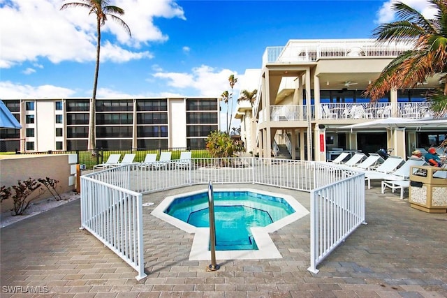 view of swimming pool featuring a community hot tub and a patio area